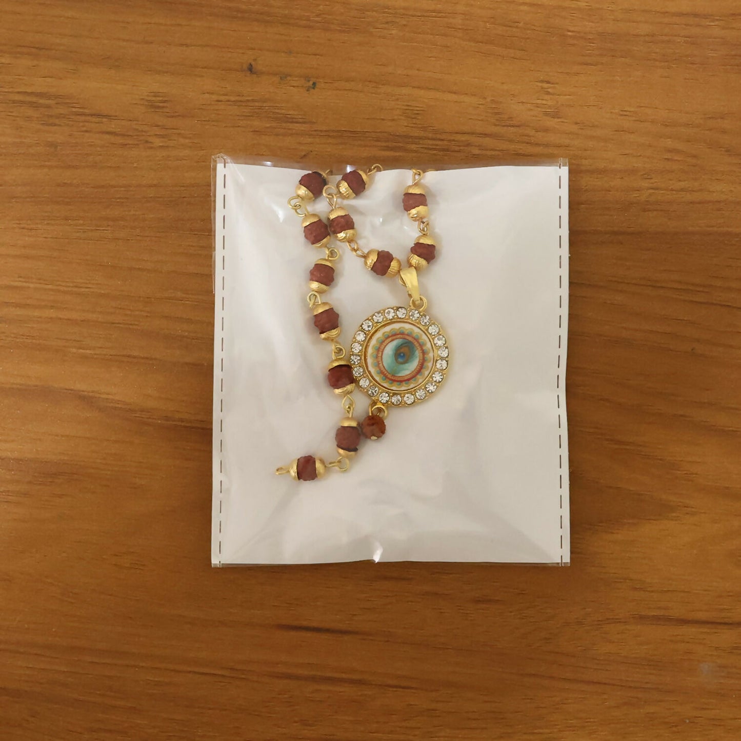 Side view of Rudraksha necklace and bracelet set with gold details