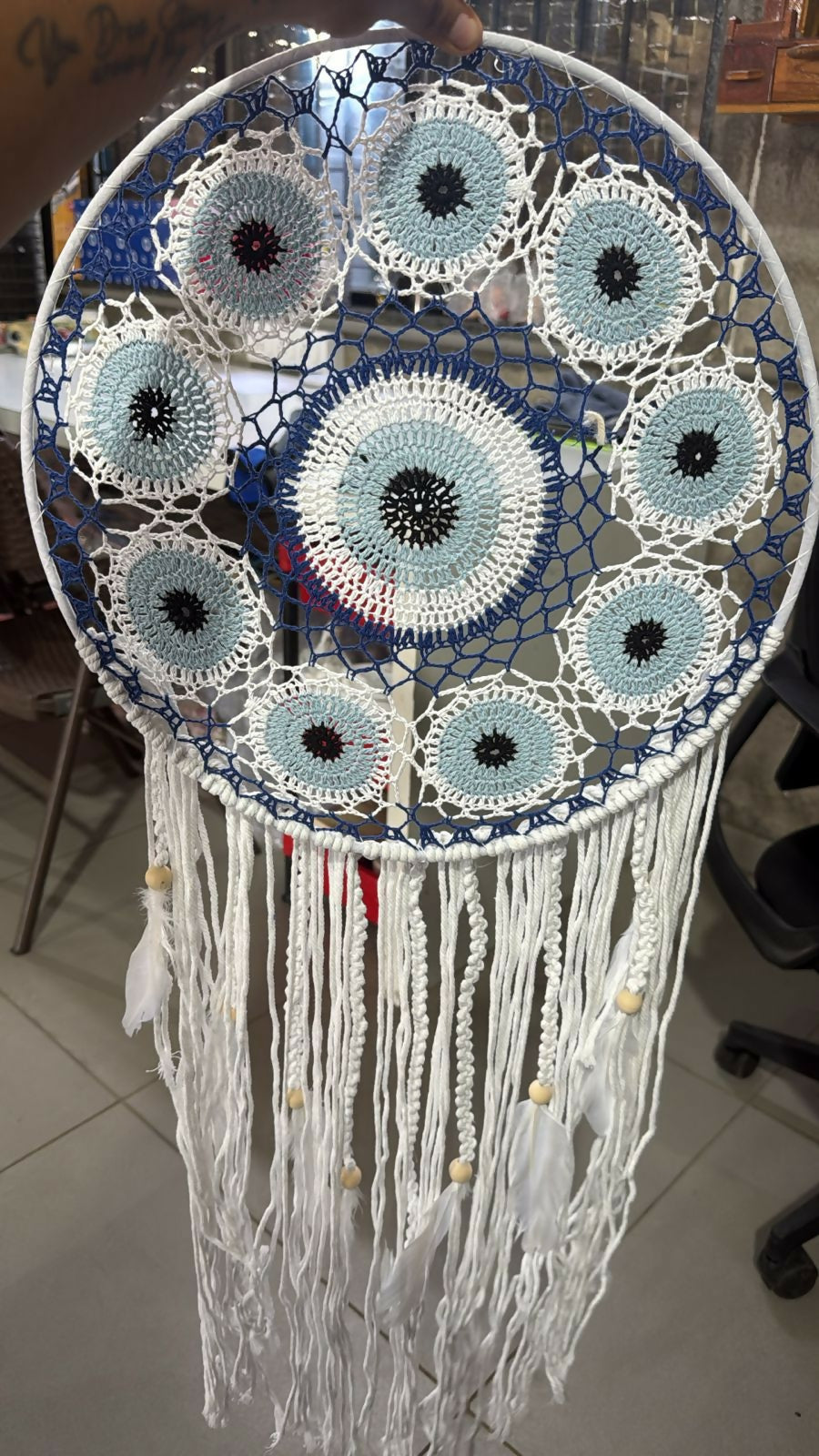 Dream catcher hanging on wall in bohemian styled room