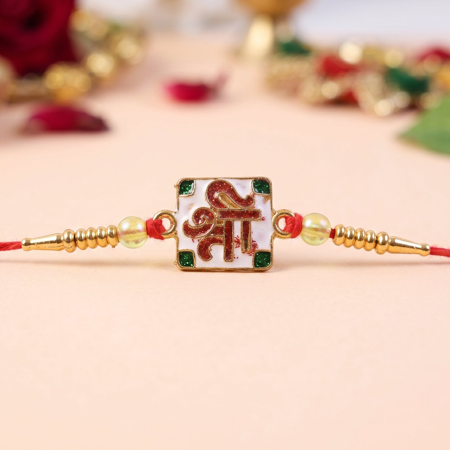 Shree Symbol Square Rakhi with Green Stones and Gold Beads