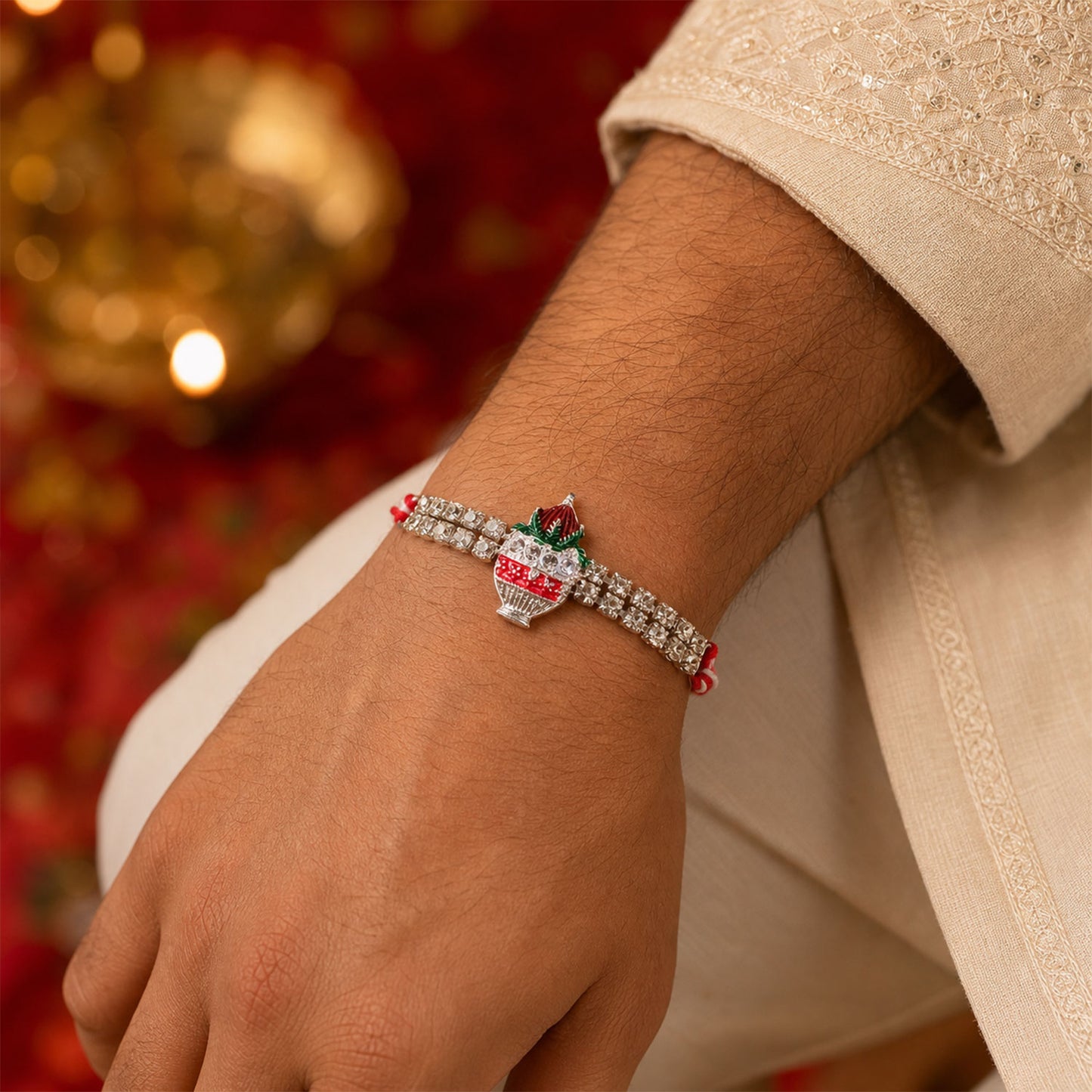 Festive Rakhi showcasing Kalash Charm, leaf detail and wrist style for Festive Use