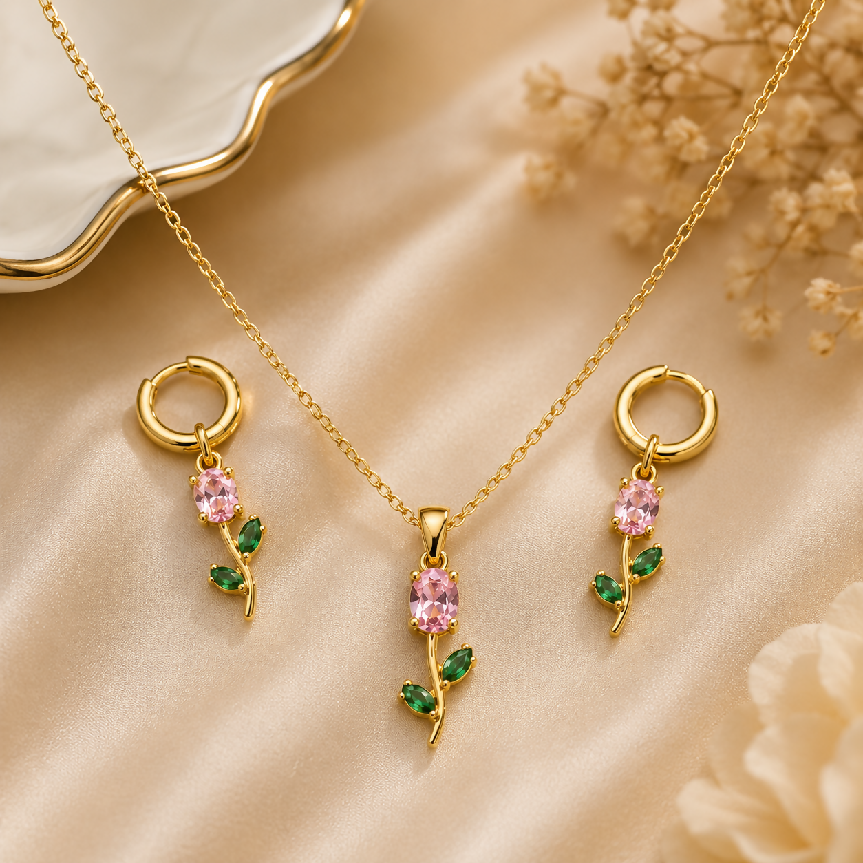 Close up view of the pink crystal floral pendant with green leaf design.