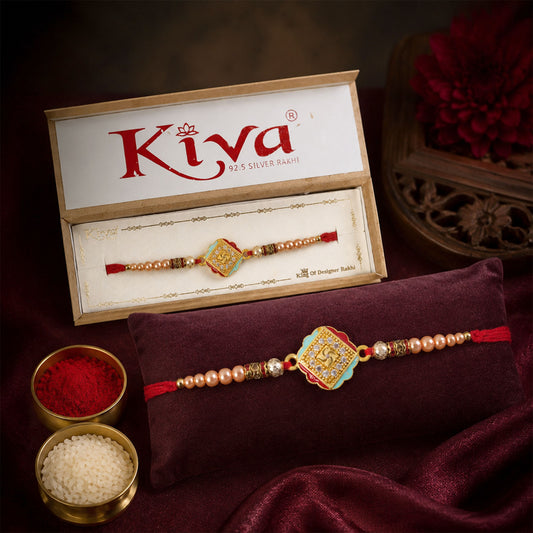 Golden Swastik AD Stone Rakhi with Turquoise-Red Meenakari and Pearl Beads