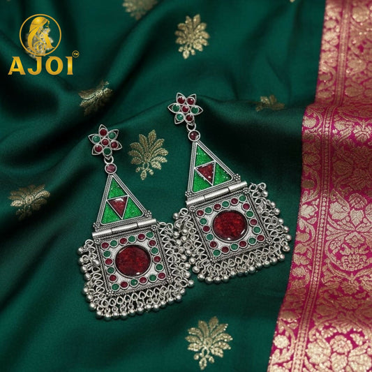 Silver geometric tribal earrings with prominent red stone and green accents