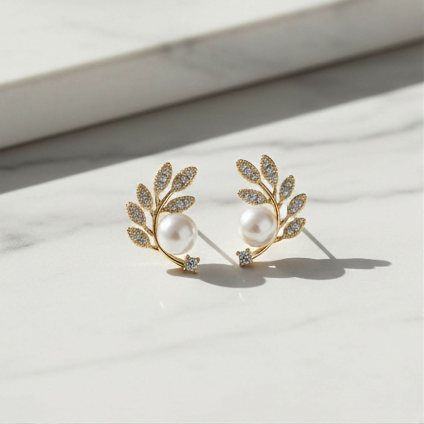 Crystal and pearl details on botanical ear climbers