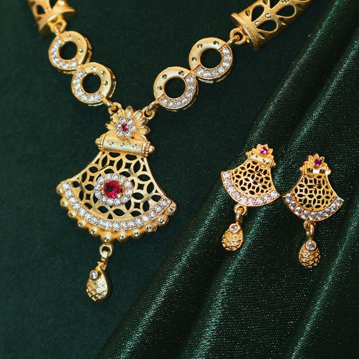 Handcrafted gold plated pendant with white AD stones and red gemstone
