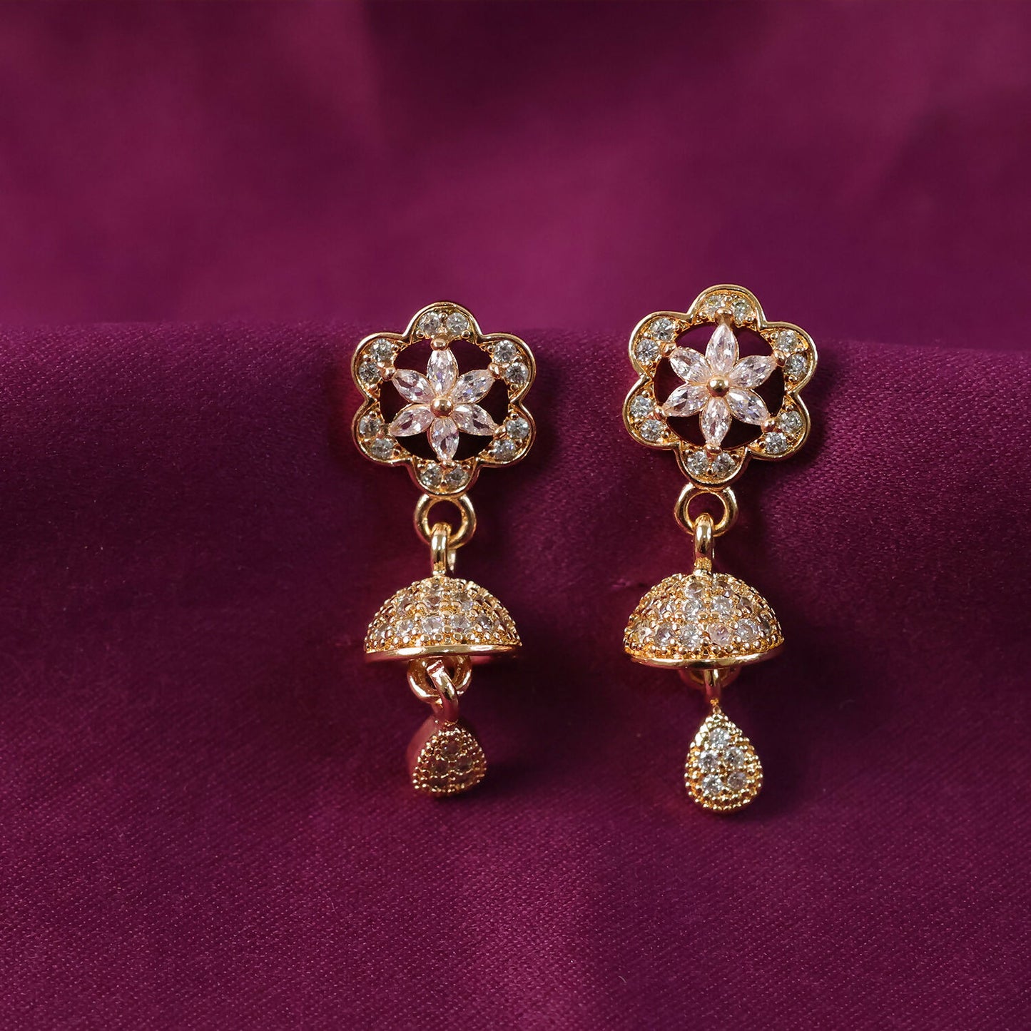 Side view of elegant rose gold starburst drop earrings with crystal details