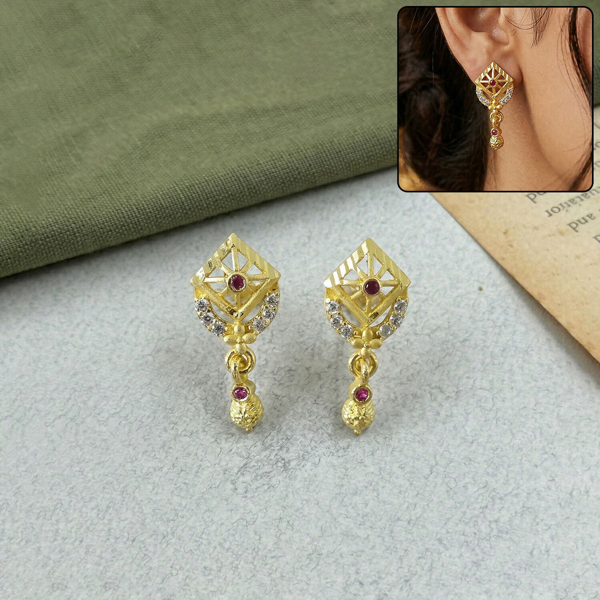 Gold plated ethnic drop earrings with intricate leaf pattern and stone accents