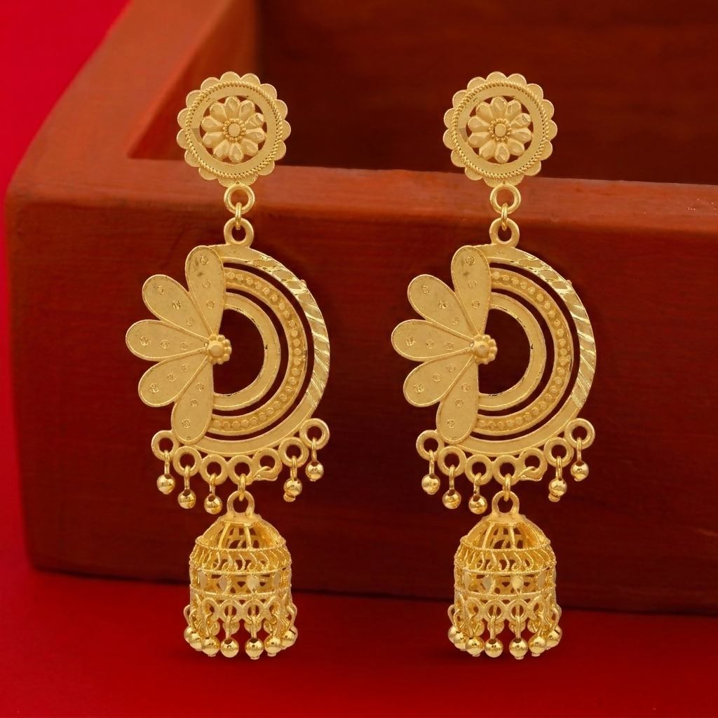 Close-up of a pair of antique style gold jhumka earrings with intricate filigree work