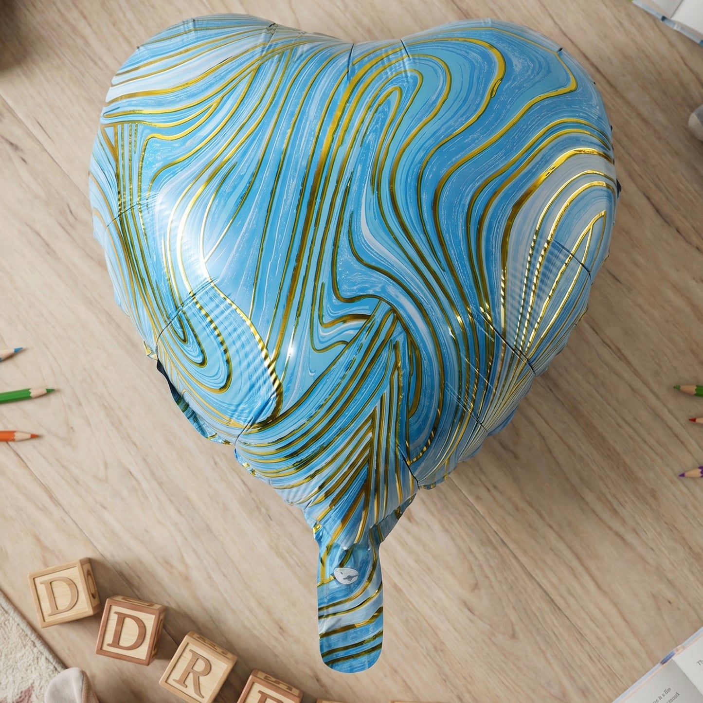Blue Marble Heart Foil Balloon hanging at party
