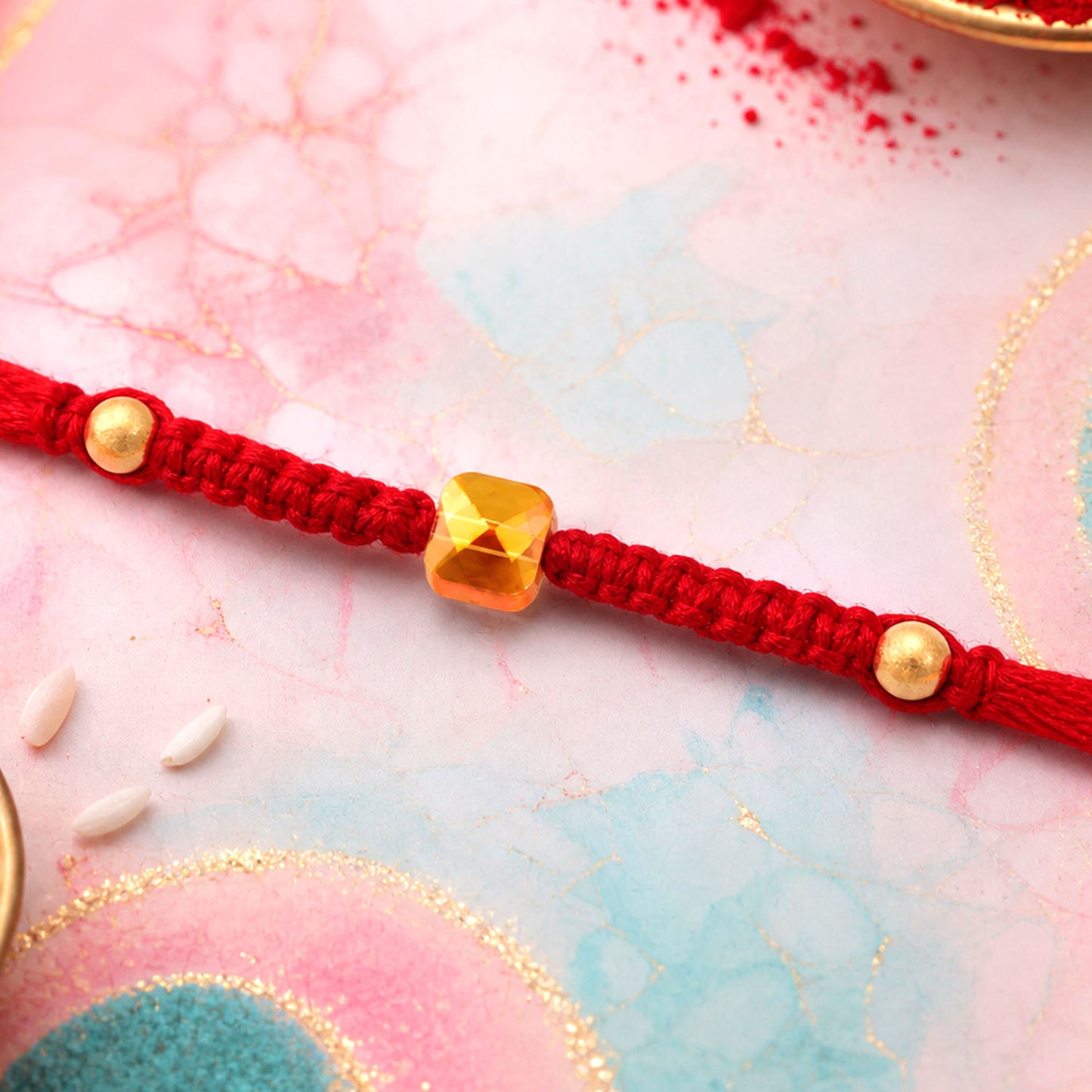 Red Braided Rakhi with a Bold Square Amber Crystal Bead Pendant