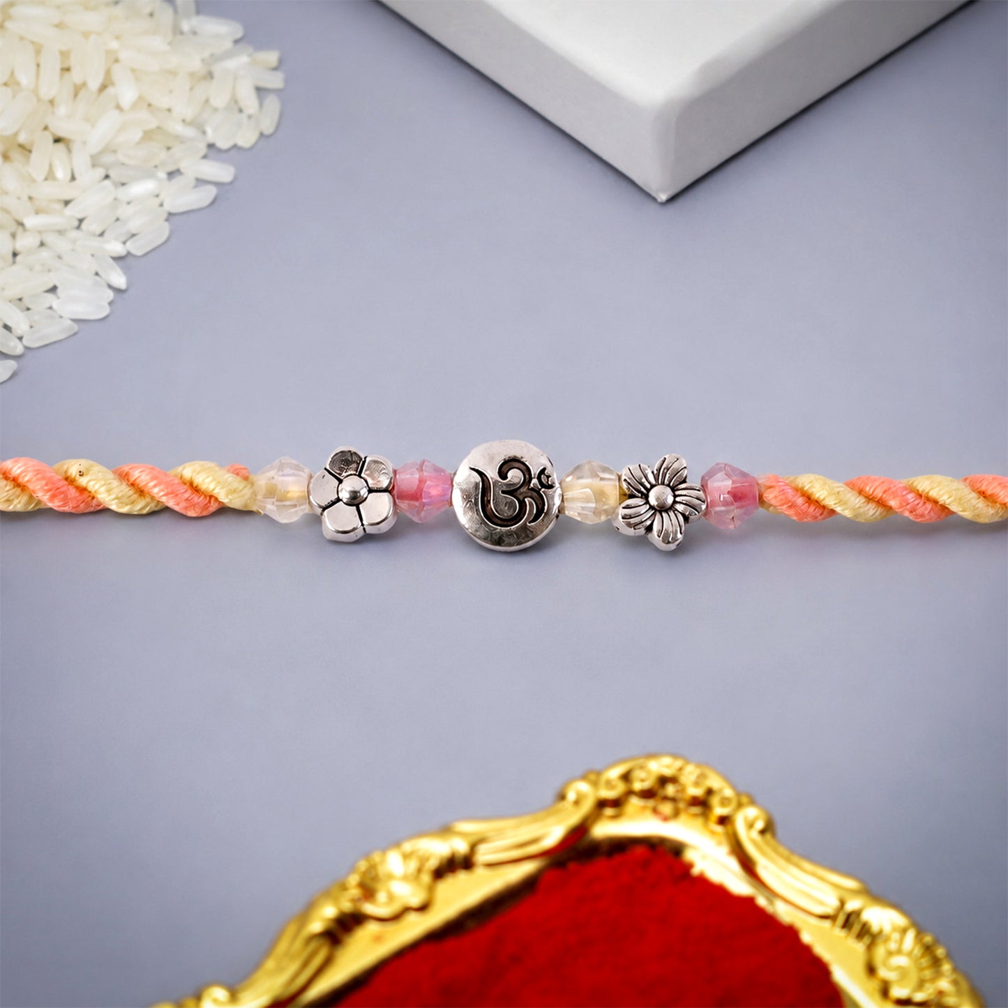 Graceful Pastel Bracelet Rakhi with Silver Centre and Delicate Raksha Bandhan Beauty