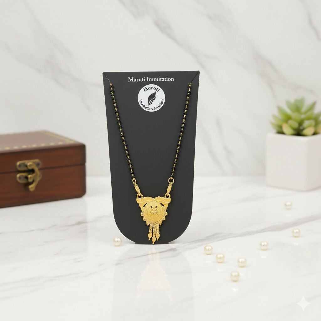 This stunning pendant, made of durable imitation metal and finished in gold tone, features detailed craftsmanship and a regal tassel drop.