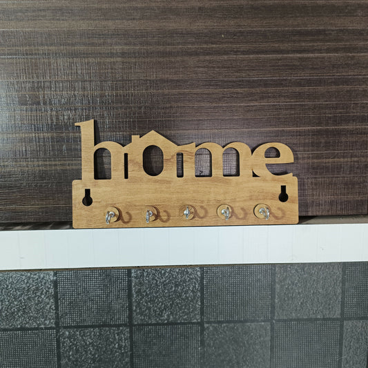 Decorative wooden key holder for wall with "Home" text and metal hooks in living room setting