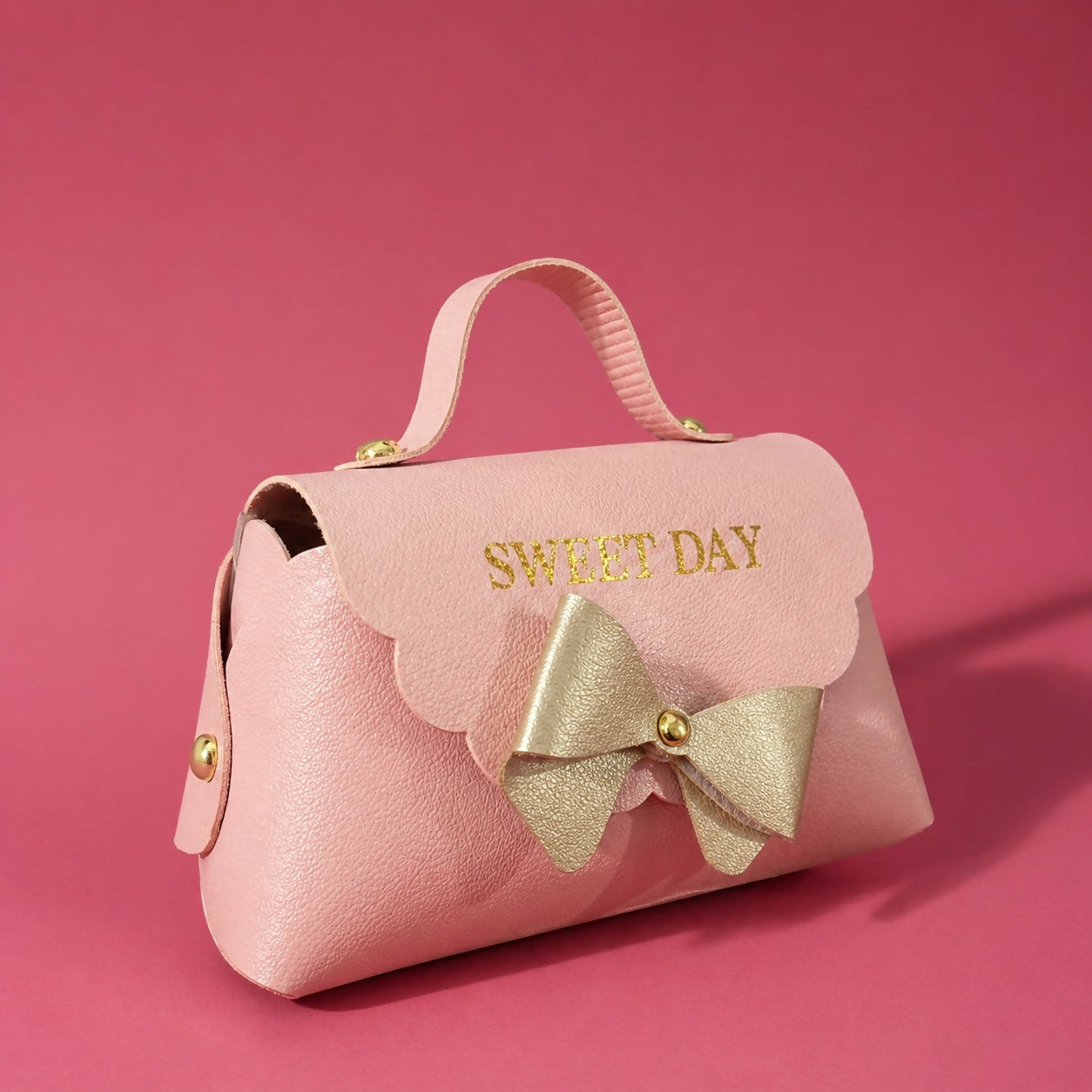 Pink mini handbag showing bow detail