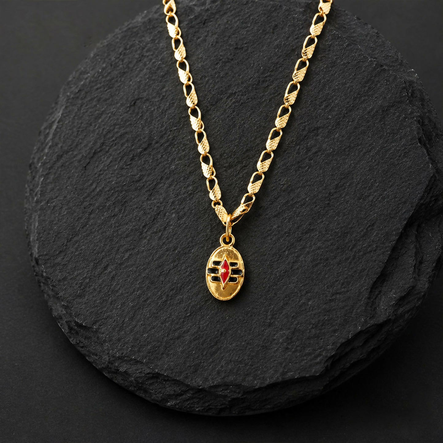 Necklace displaying gold-tone Shiva Tilak pendant and chain