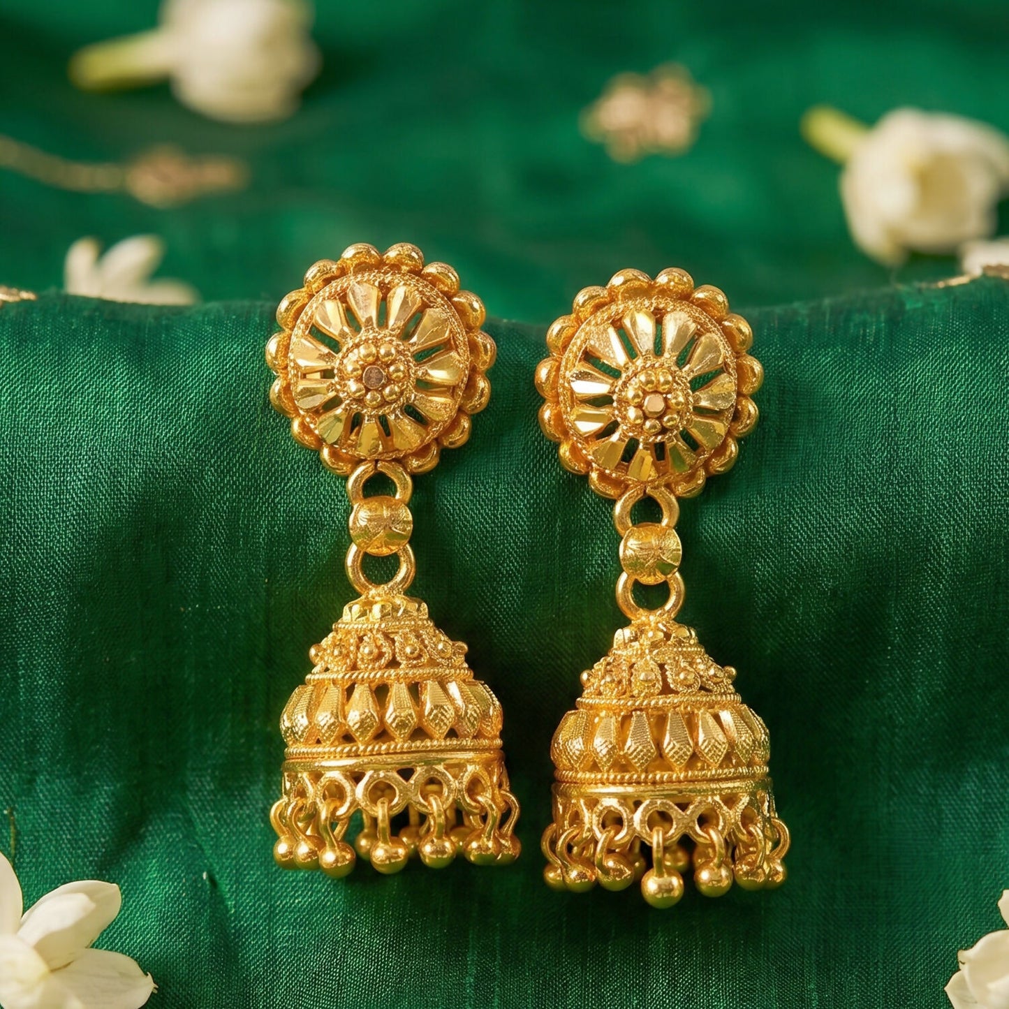 Side view of gold jhumka earrings with pearls