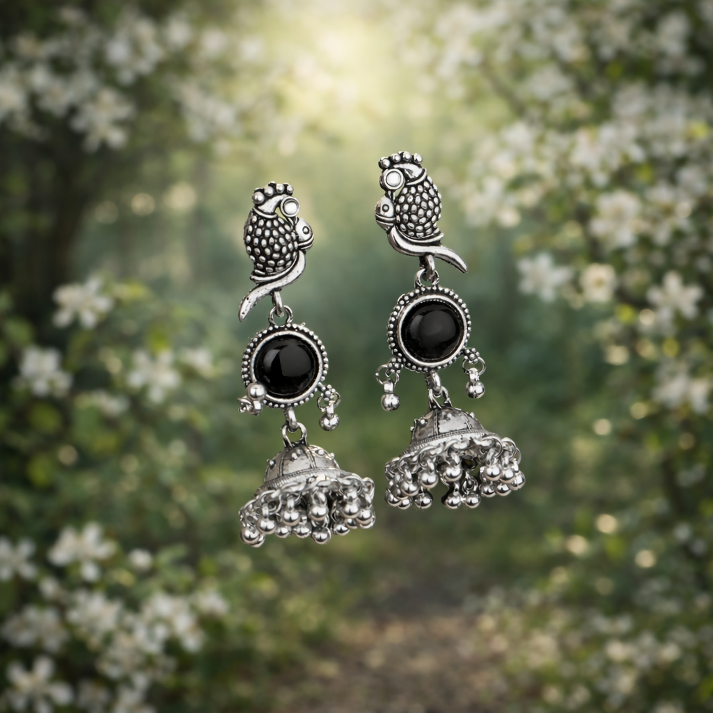 Side angle of oxidized jhumka earrings highlighting traditional ghungroo-style drops