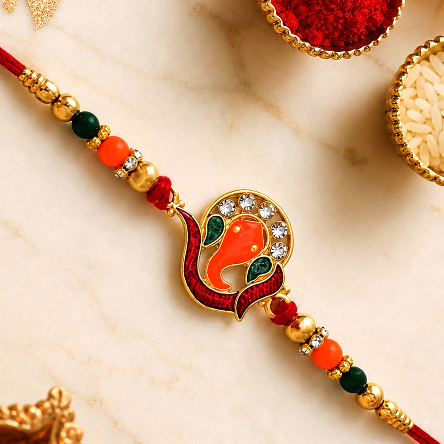 Ganesha Rakhi – Golden with Red-Green Beads & Stone Work