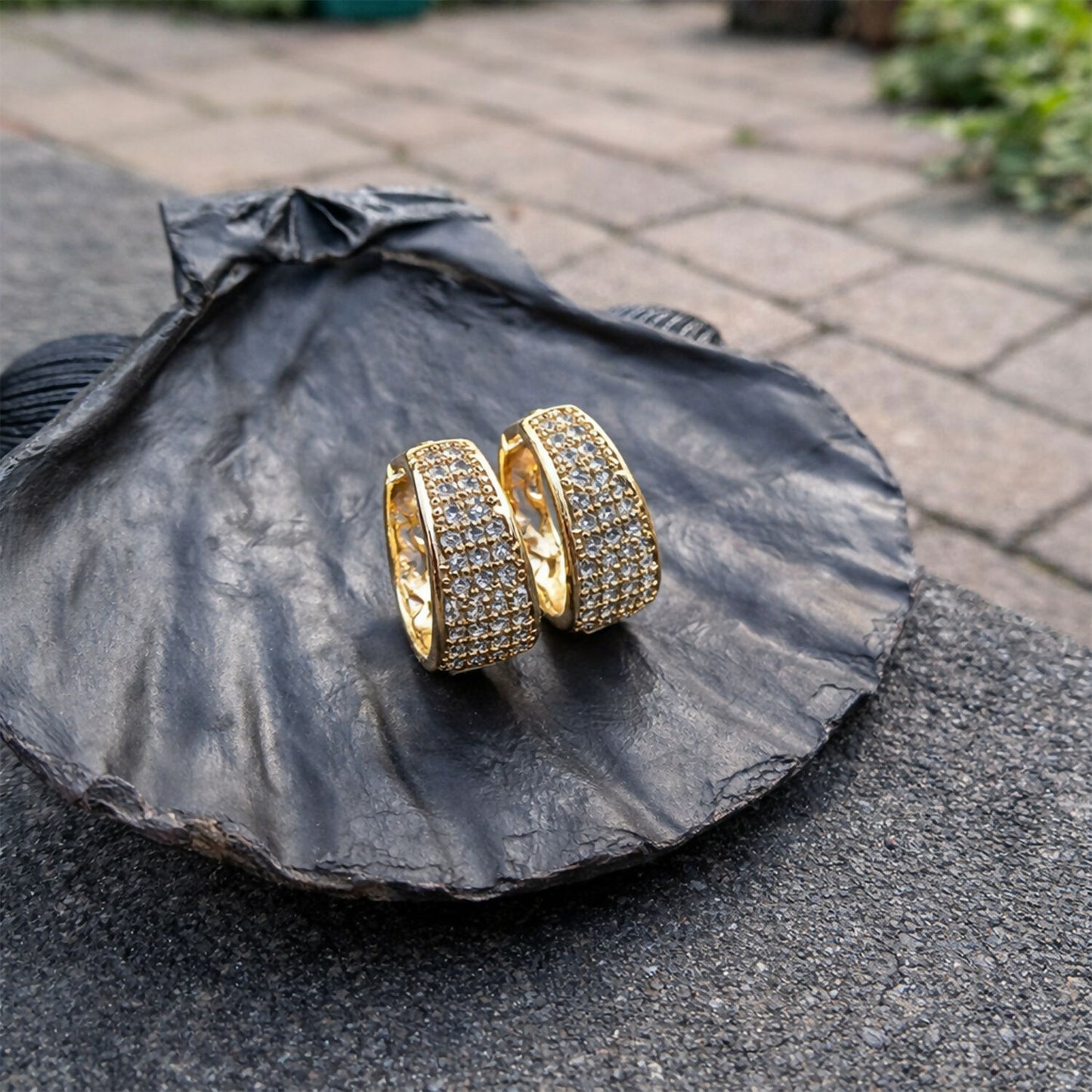 Elegant gold crystal-studded hoop earrings paired with formal wear