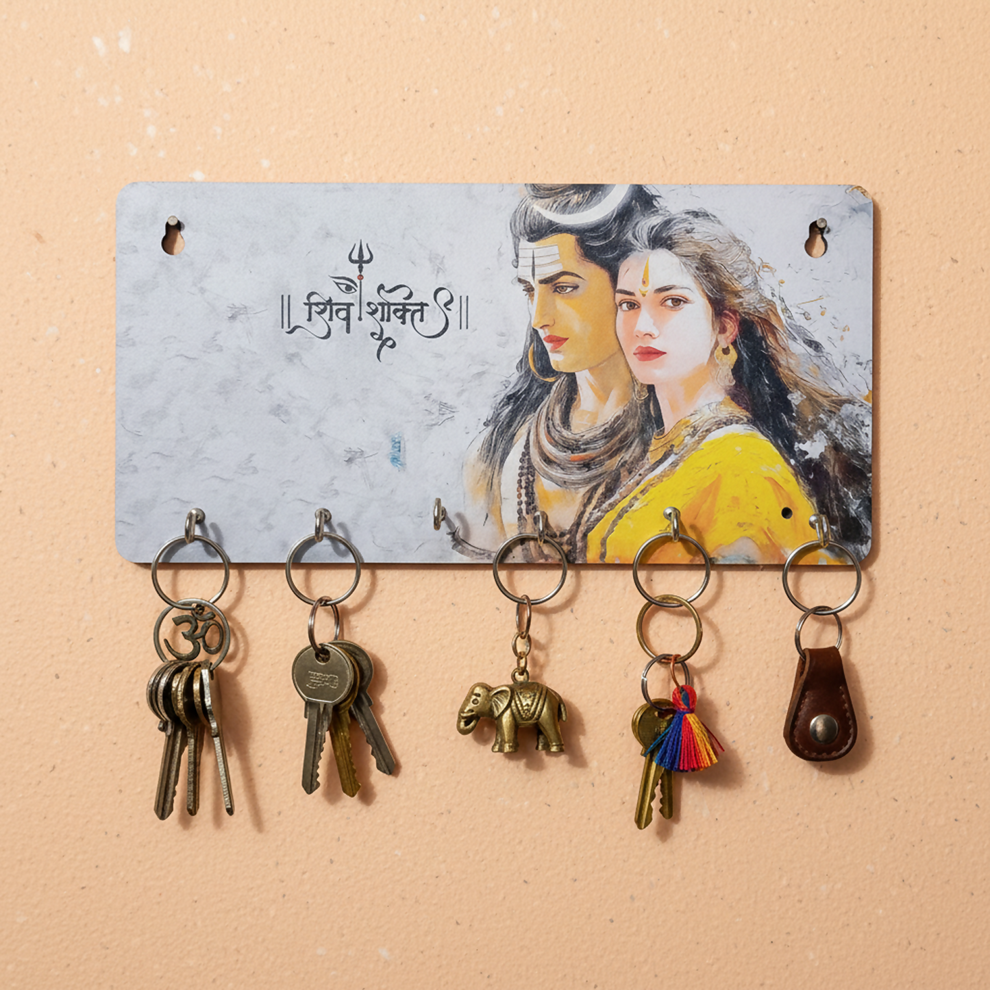 Close-up of metal hooks on spiritual key holder with Hindu deity prints