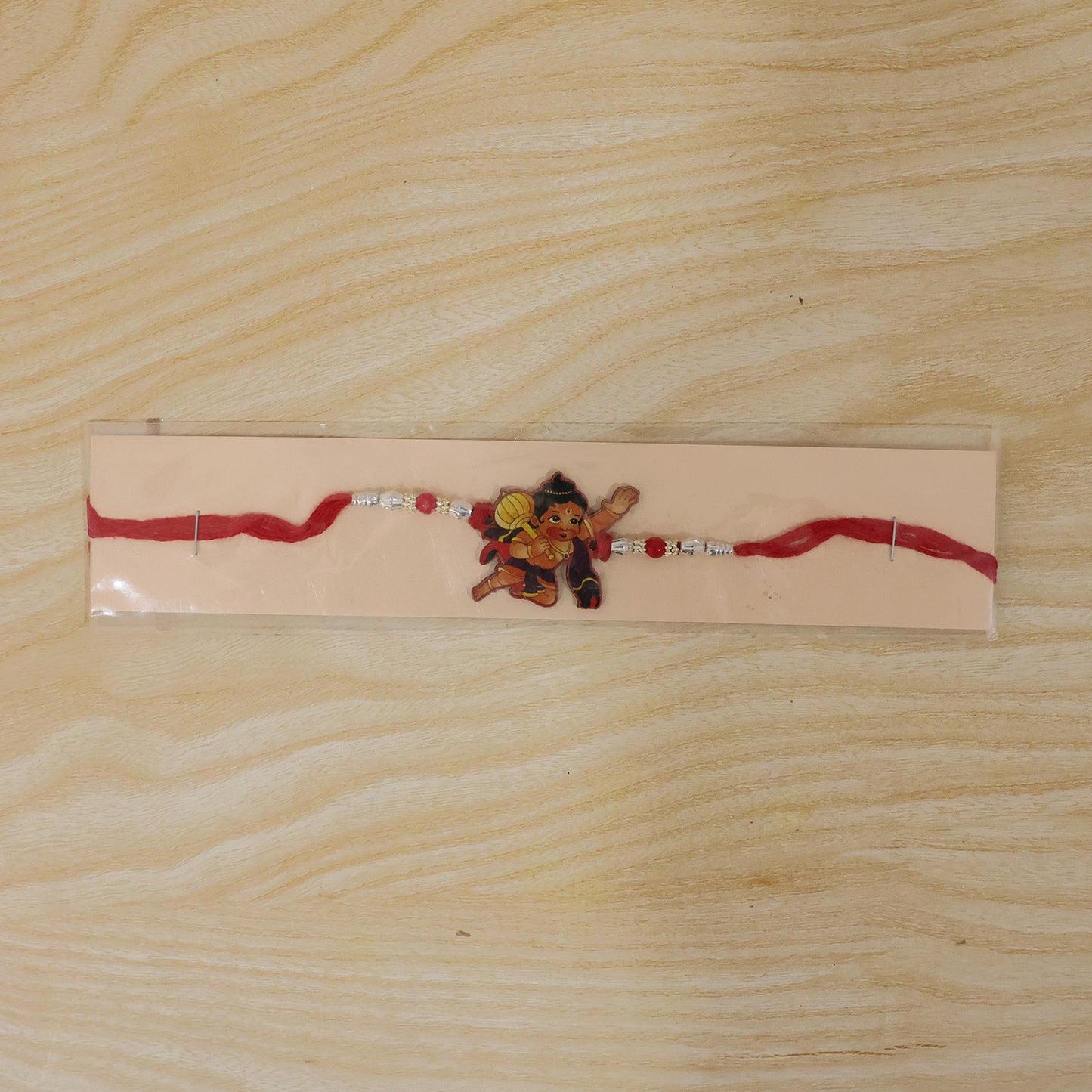 Bal Hanuman Cartoon Rakhi with Red Beads and Silver Chain