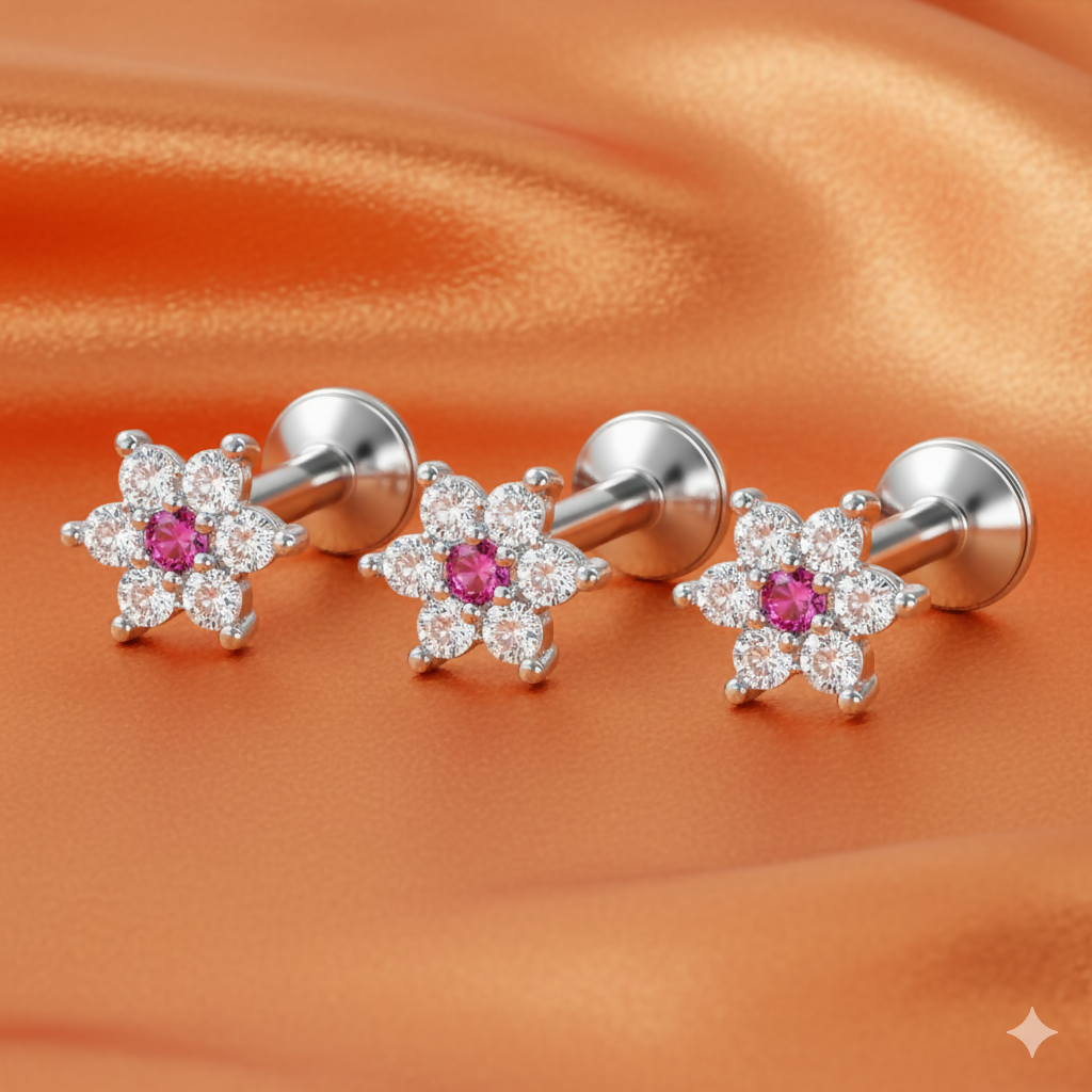 Close-up of a ruby floral silver plated stud earring with cubic zirconia accents