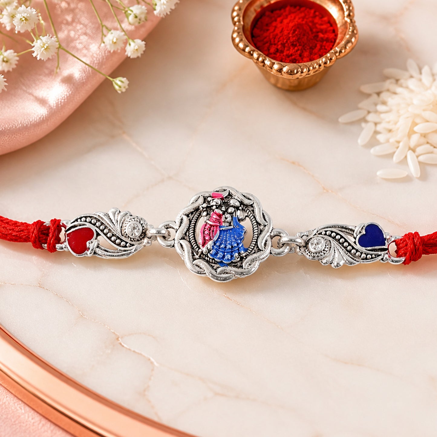 Silver-Toned Radha Krishna Rakhi with Colorful Enamel, Crystal Accents & Designer Red Thread