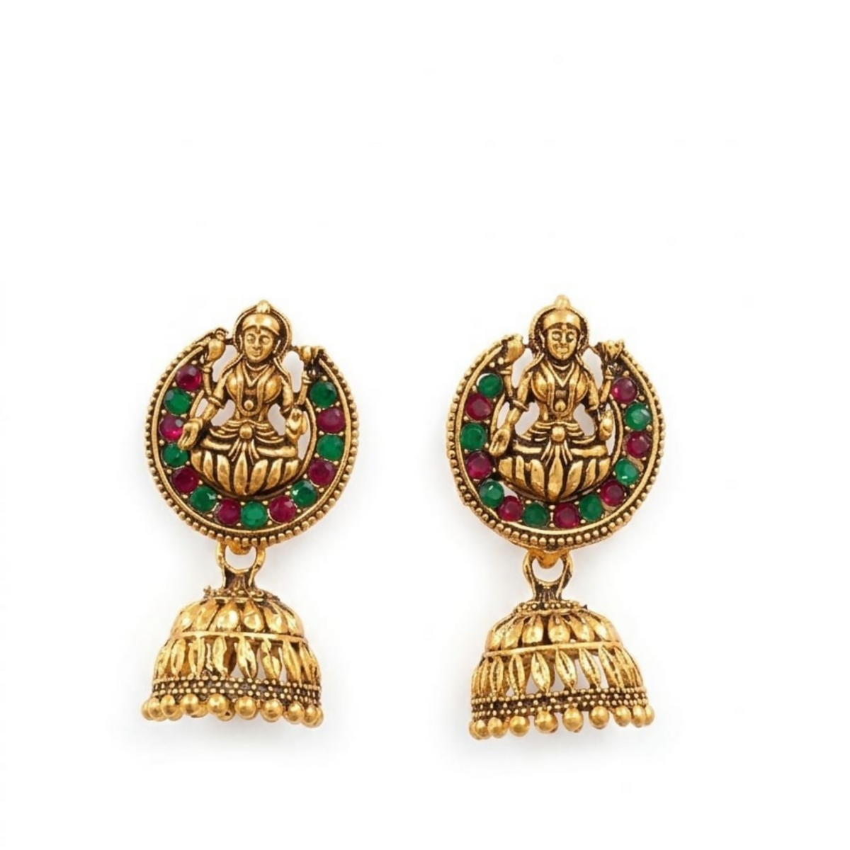 A pair of gold-toned jhumka earrings with goddess figures and red and green stones on a white background.