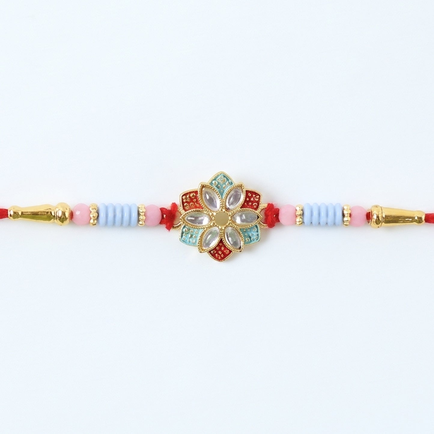 Side view of floral kundan star petal rakhi with soft tying thread