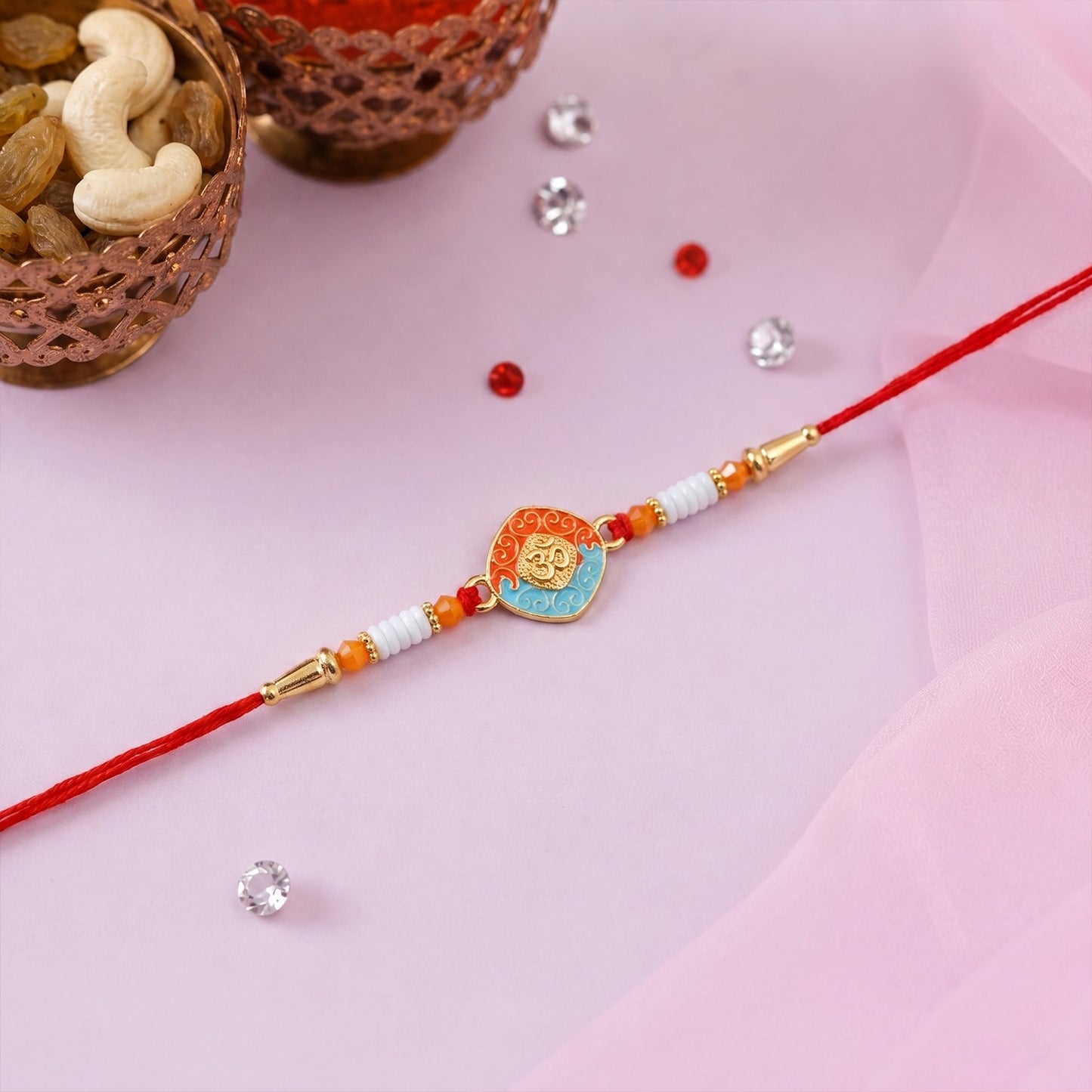 Close-up of OM Symbol centerpiece on Rakhi