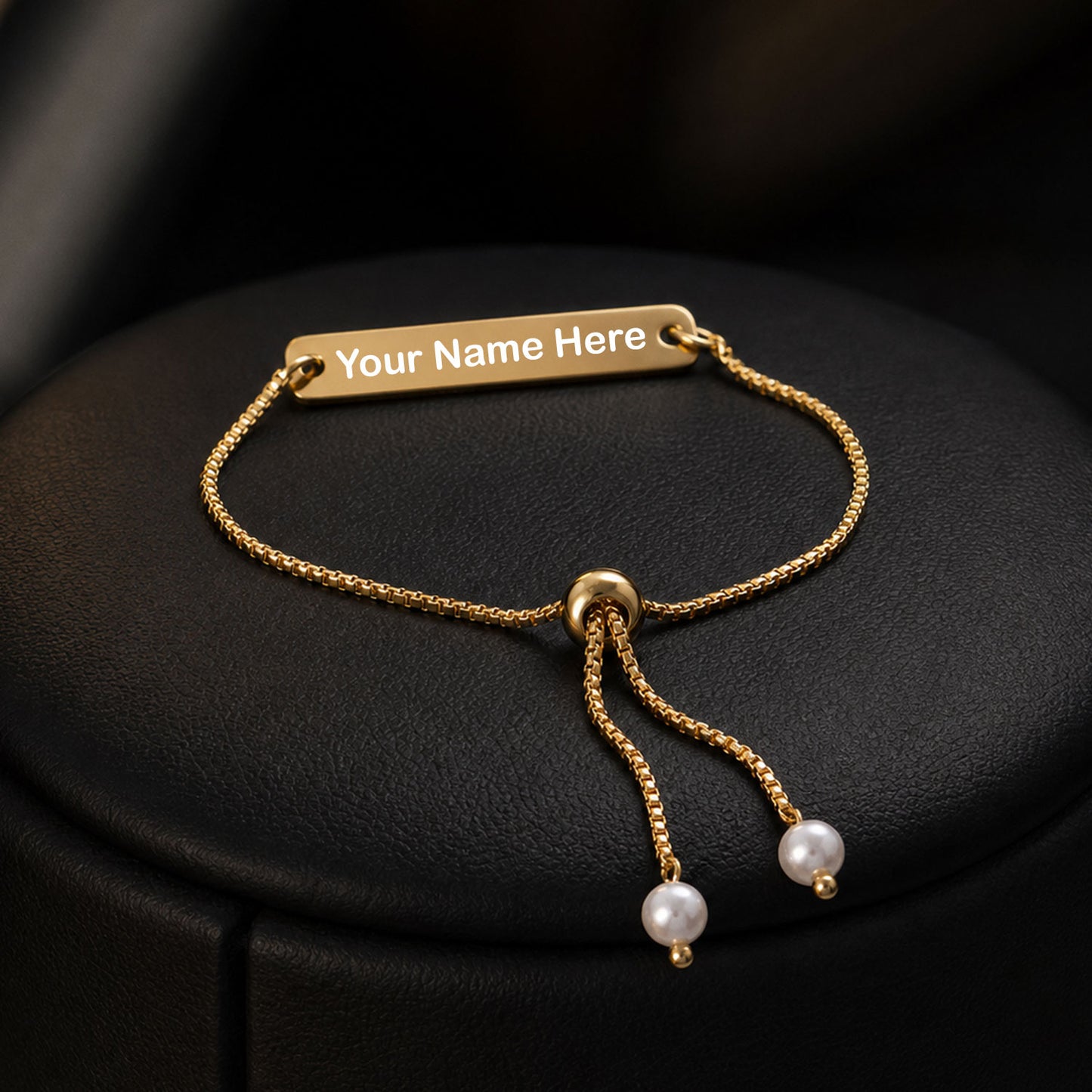 Adjustable gold tone custom name bracelet on a wrist, showcasing its fit.