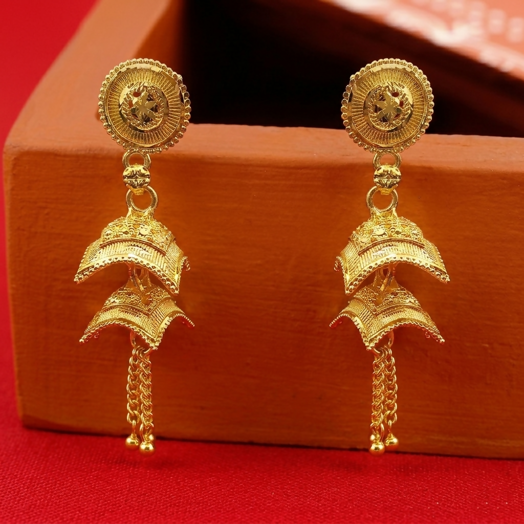 Close-up of gold plated jhumki earring intricate design