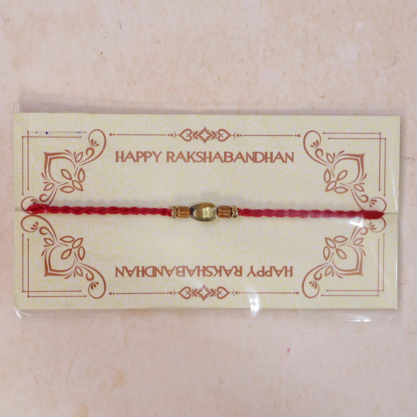 Red Thread Rakhi with Golden Oval Bead and Wooden Bead Accents