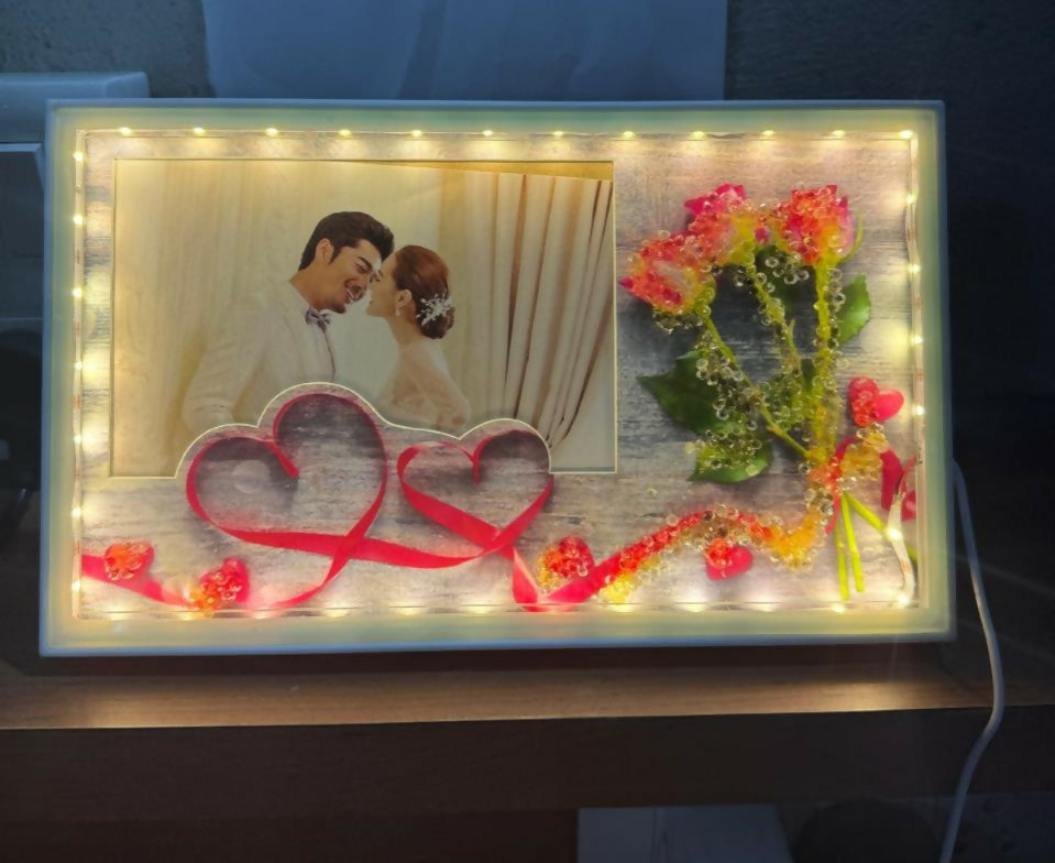 Romantic LED Photo Frame with Decorative Flowers & Heart Ribbon Design | Warm Light Illuminated Couple Picture Frame for Anniversary, Wedding & Valentine Gift | USB Powered Tabletop Love Frame for Home & Bedroom Decor