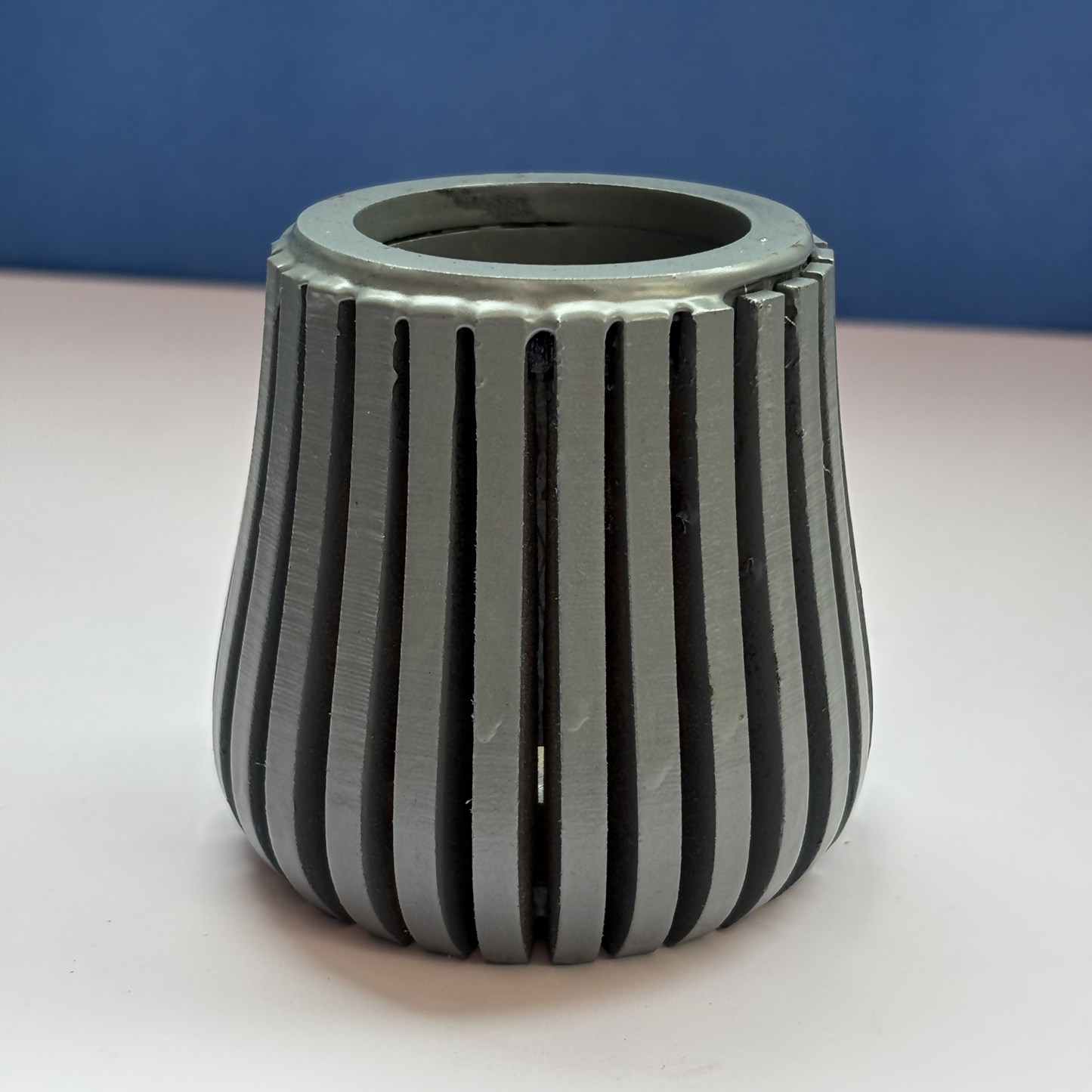 Contemporary grey wooden pen holder on a modern study table.