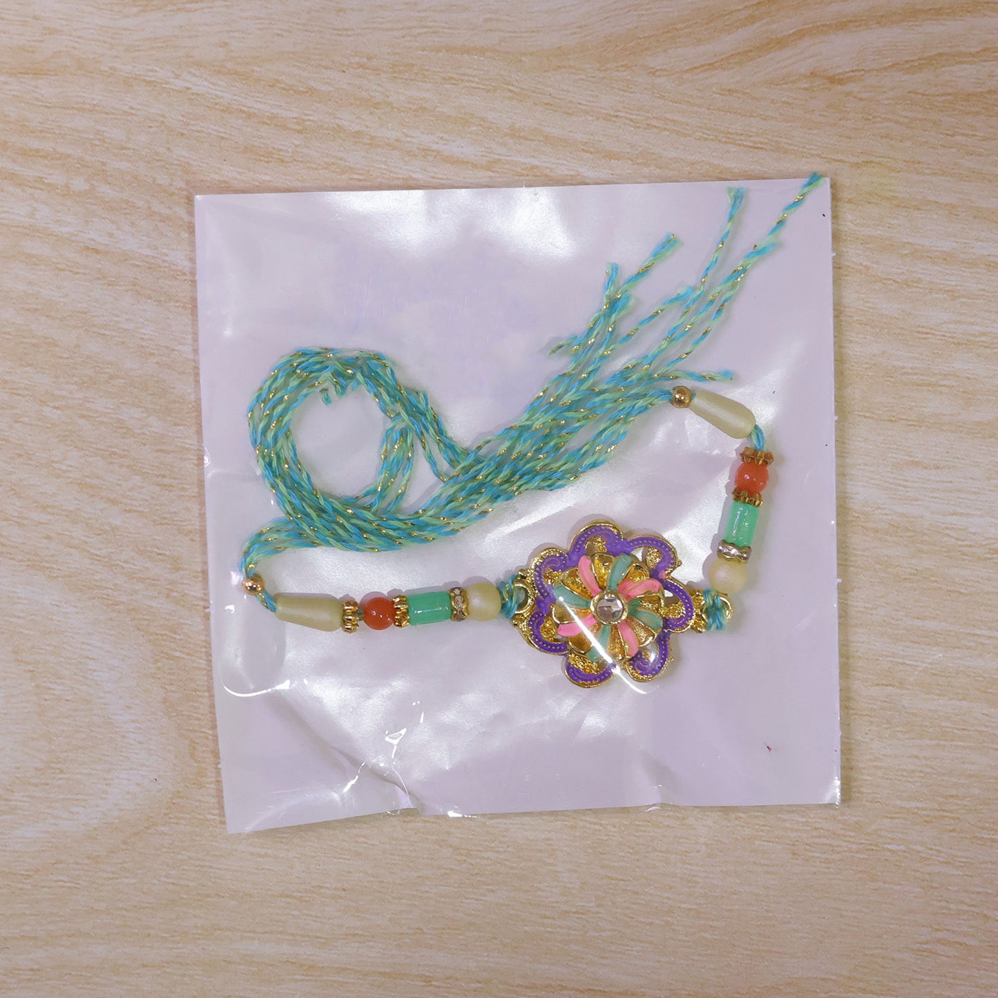Floral Bloom Rakhi with Cream Thread, Pastel Beads and Soft Enamel Petals for Gifting