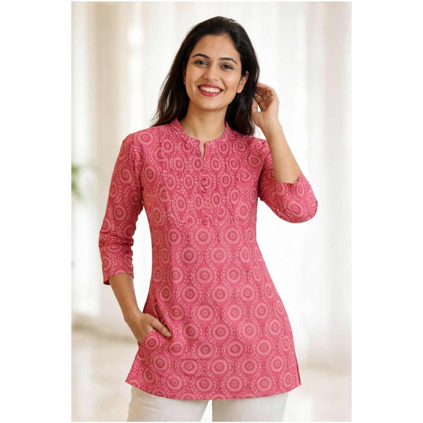 Close-up of all-over circular printed design on women's pink short kurti