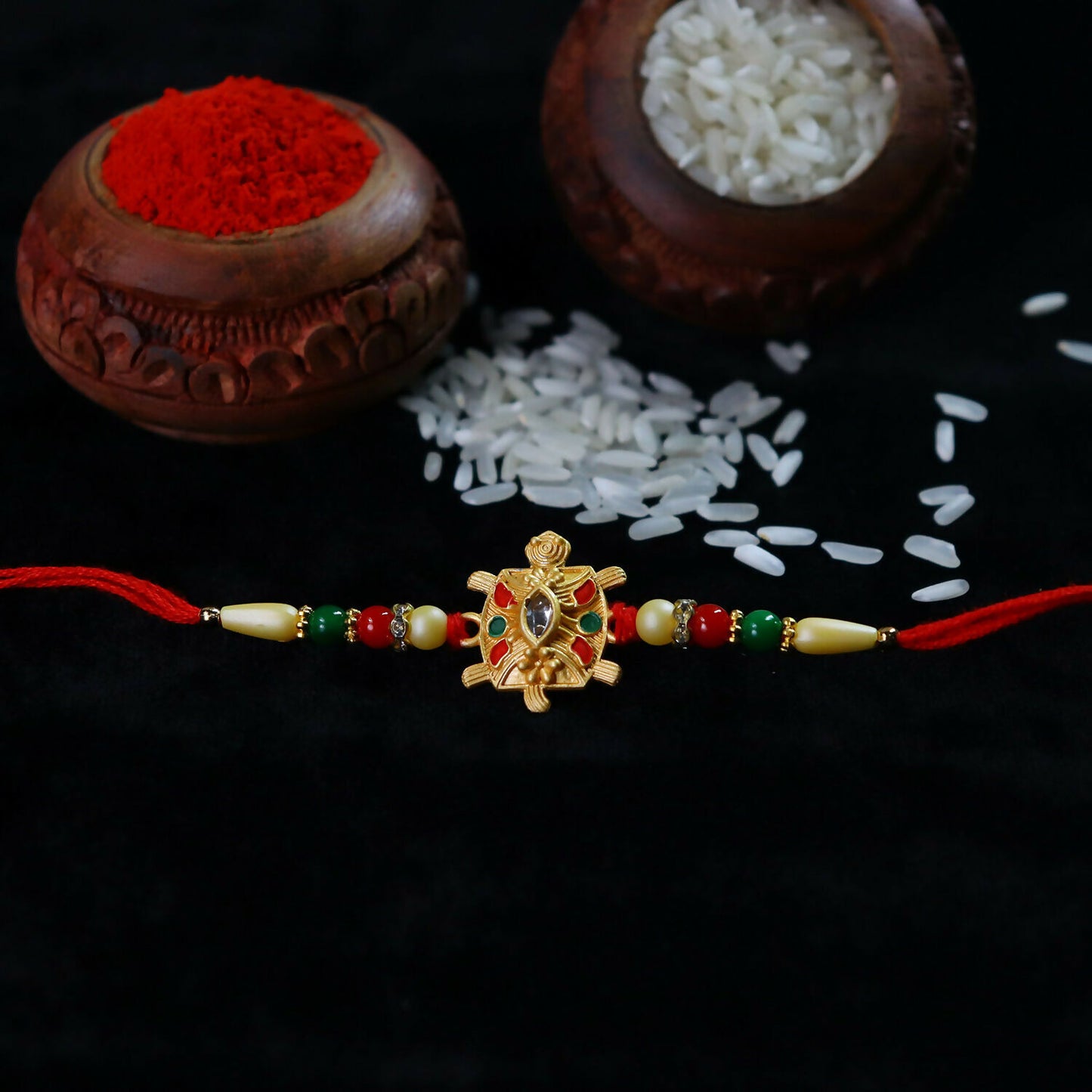 Close-up of Turtle Rakhi threads and beads
