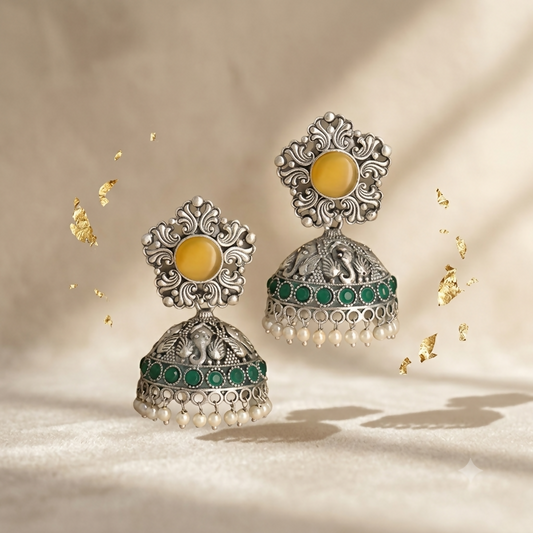 Full display of oxidised silver jhumka earrings with green stones and pearls