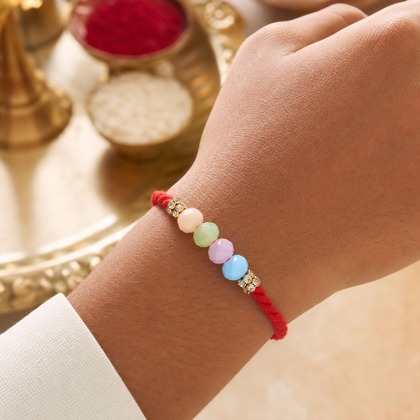 Red Twisted Cord Rakhi with Soft Pastel Multicolour Bead Accents