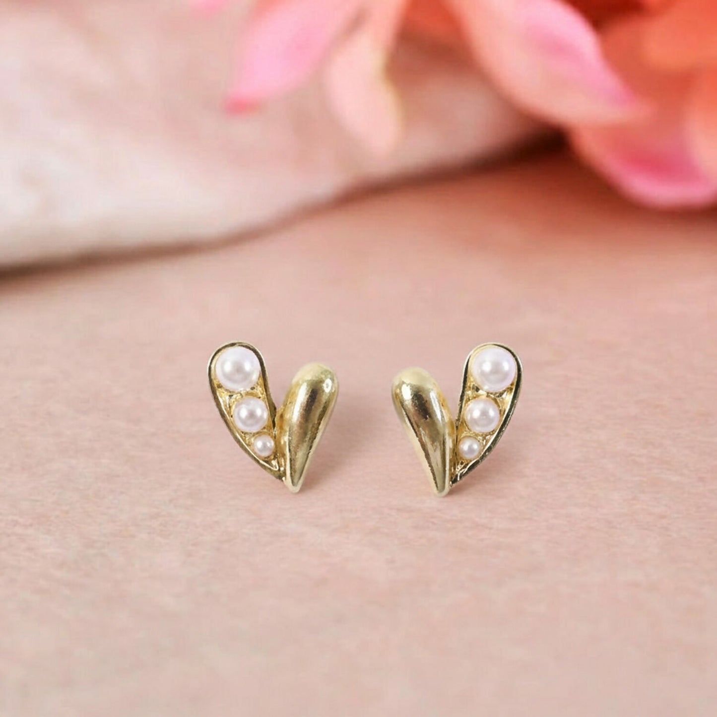 Close-up of Korean style gold pearl heart stud earrings