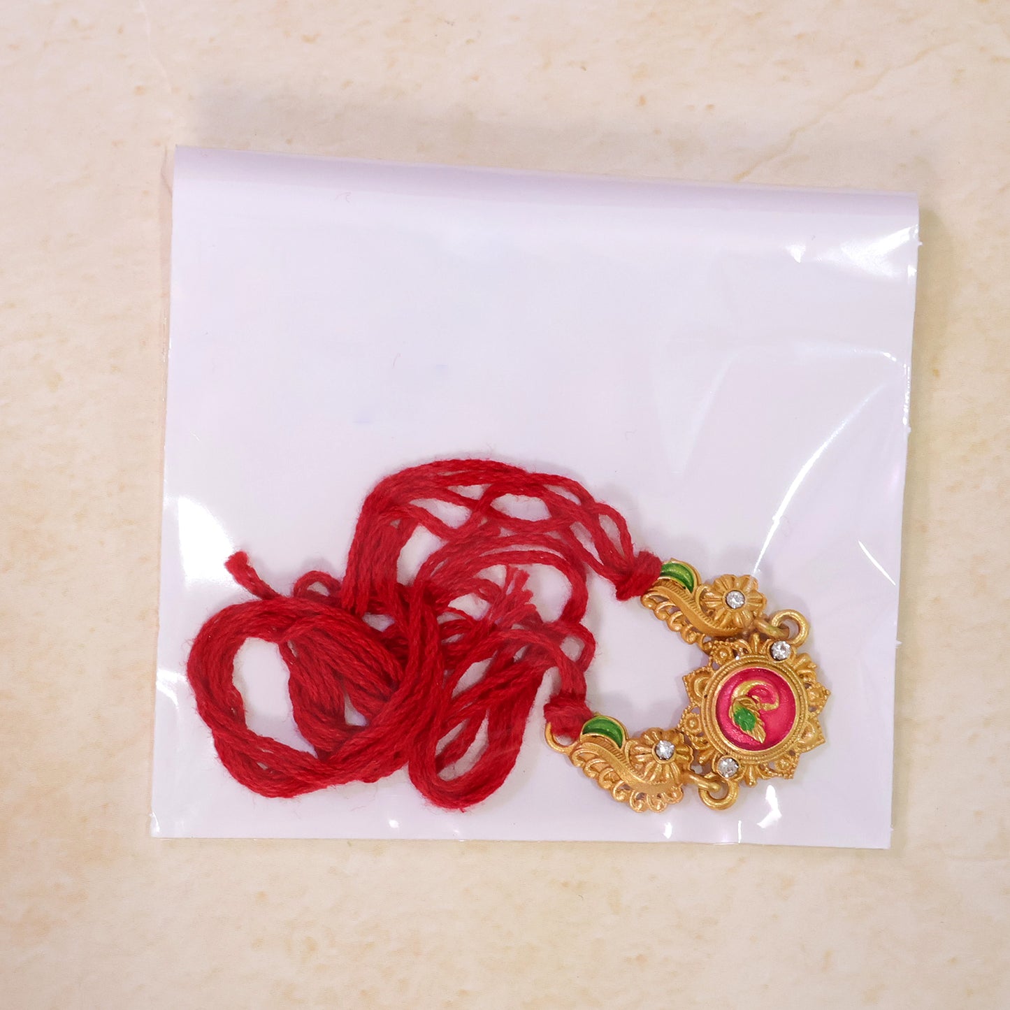 Designer Rakhi showcasing Floral Rosette, gold trims and gift style for Gift Styling