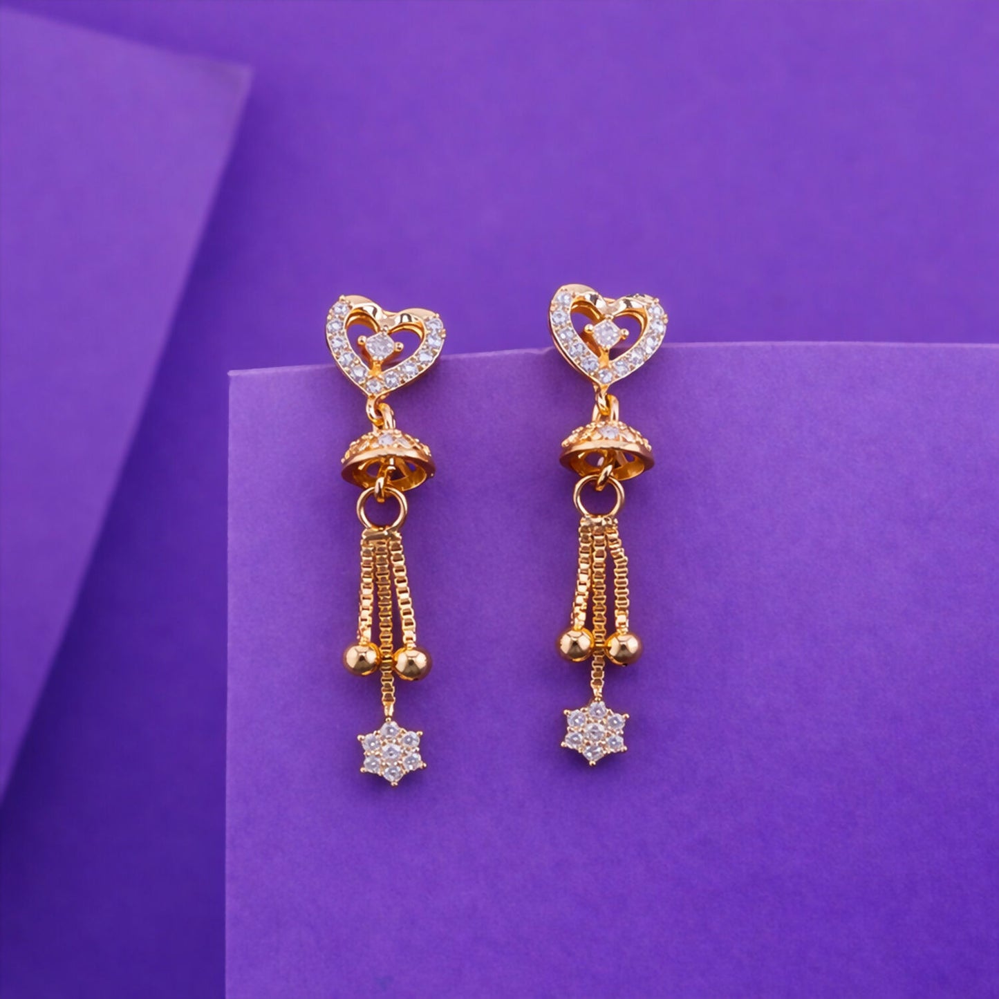 Gold plated double heart crystal drop earrings with hanging star tassel, front view