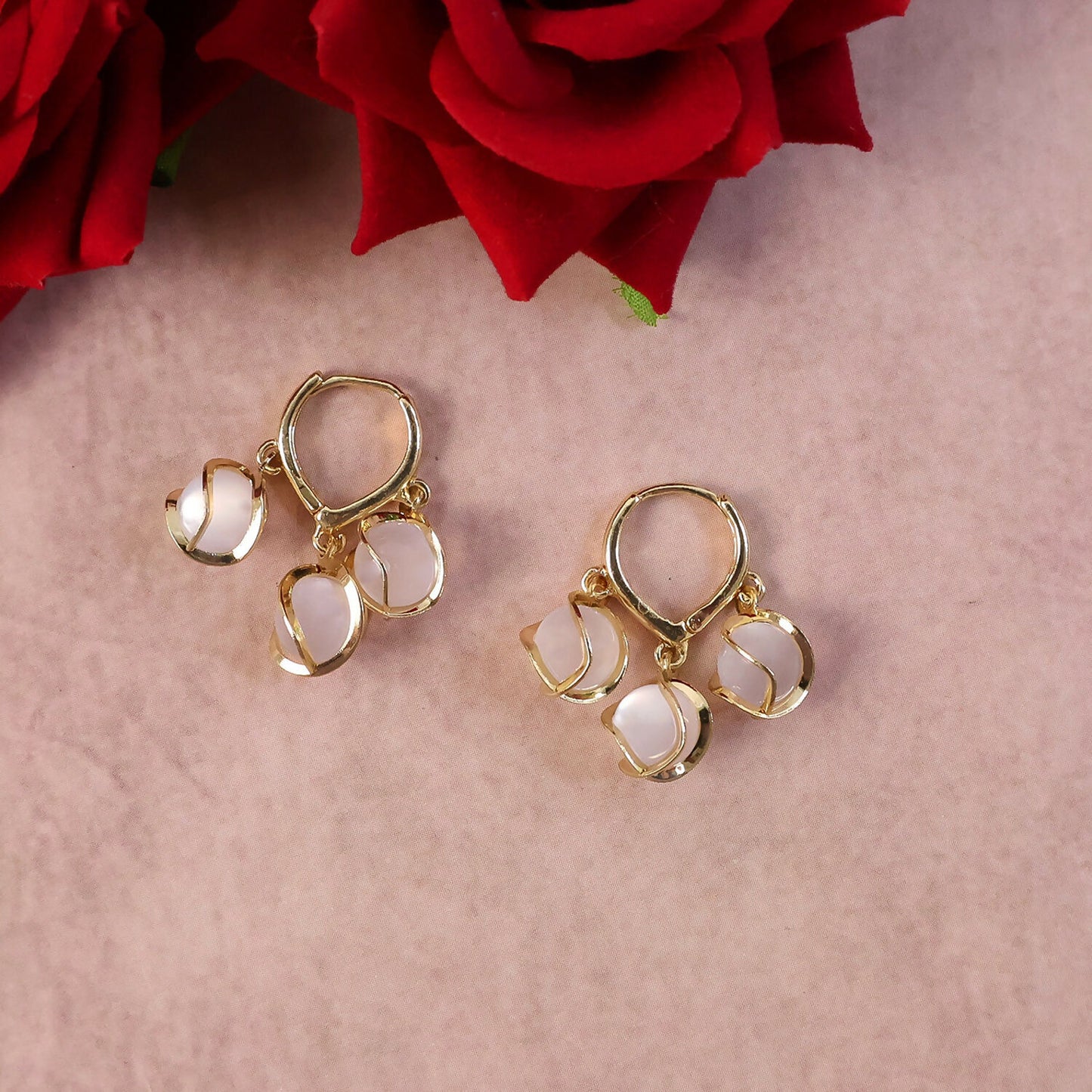 Close-up of opal cluster on gold hoop earring