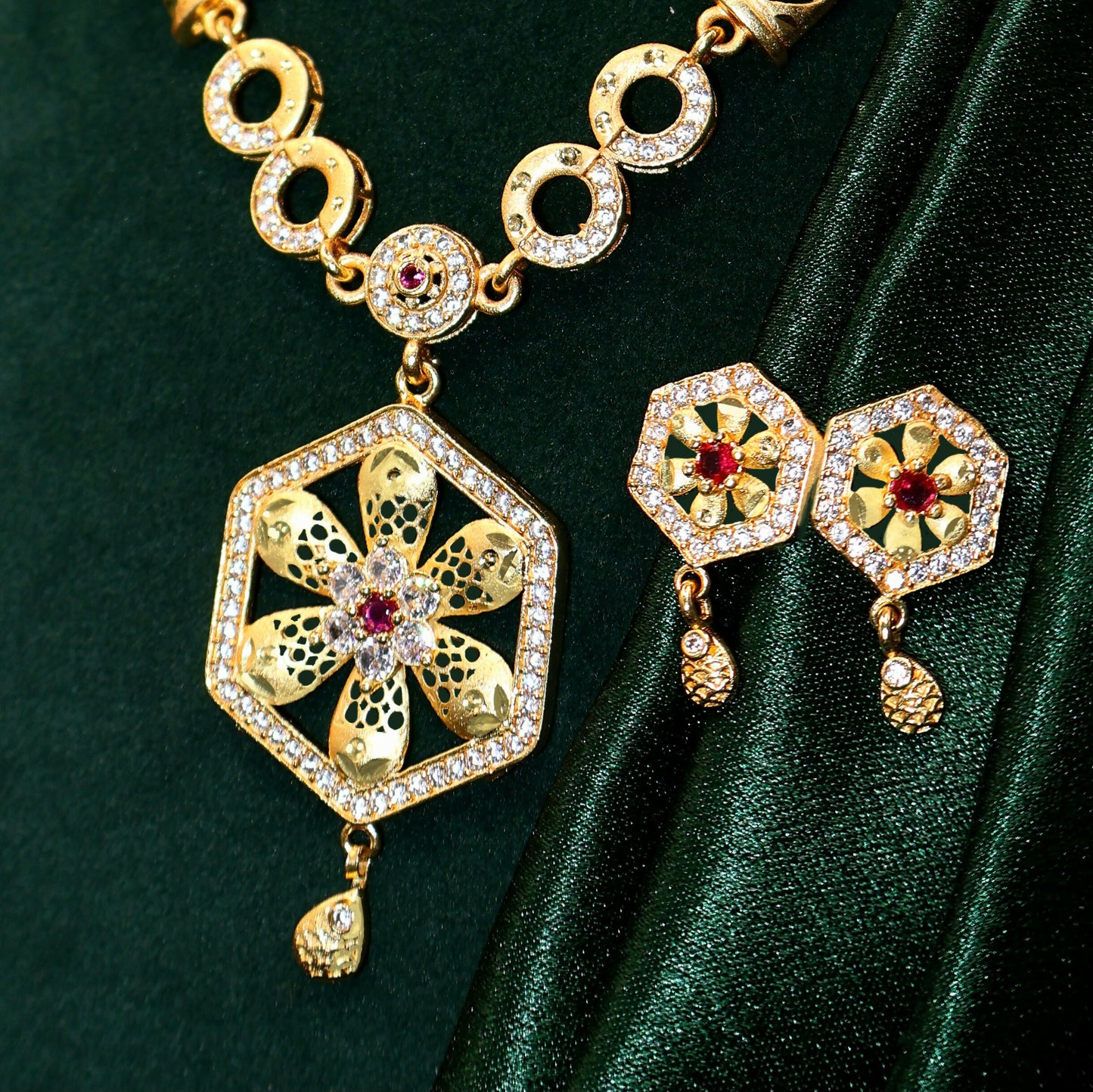 Close-up of gold plated hexagon pendant featuring shimmering embedded stones.