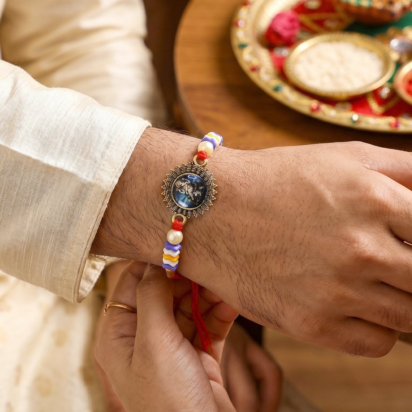 Traditional bhabhi rakhi showing latkan and bead design