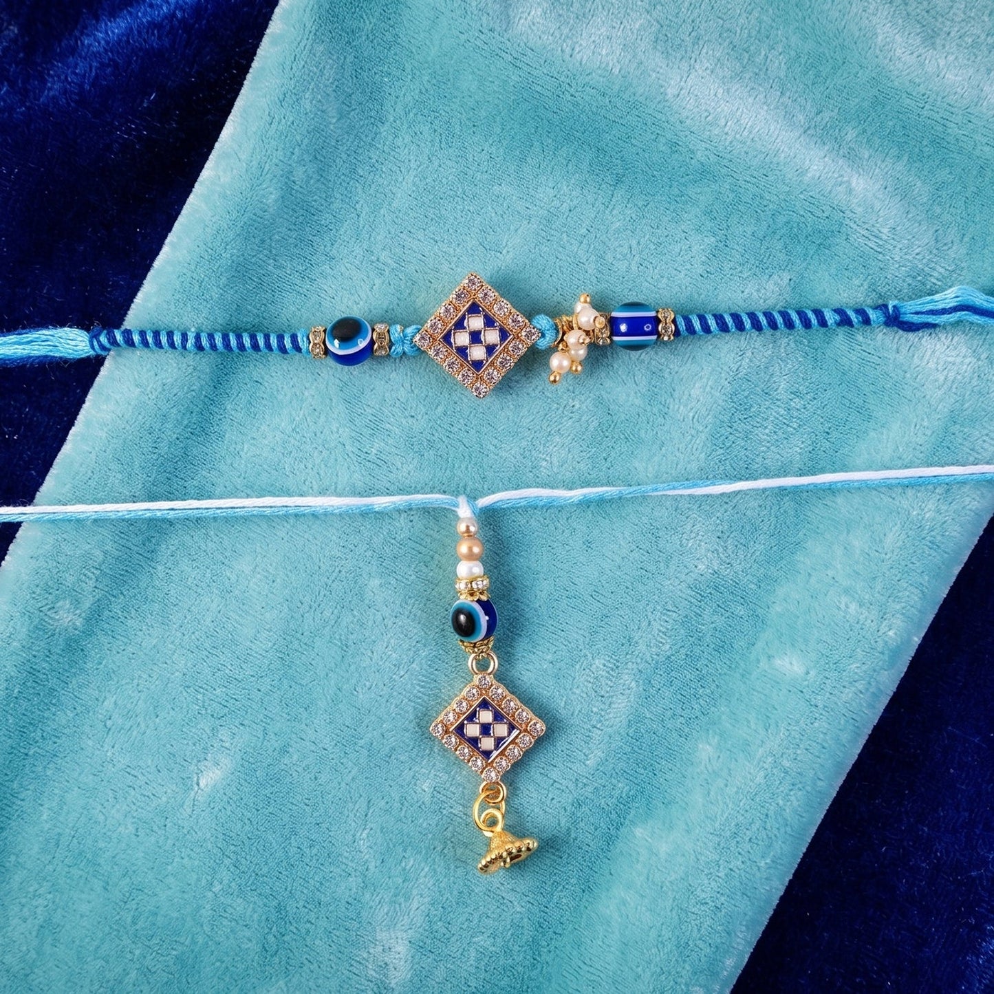 Close-up of Pearl Bhabhi Rakhi twin charm detail