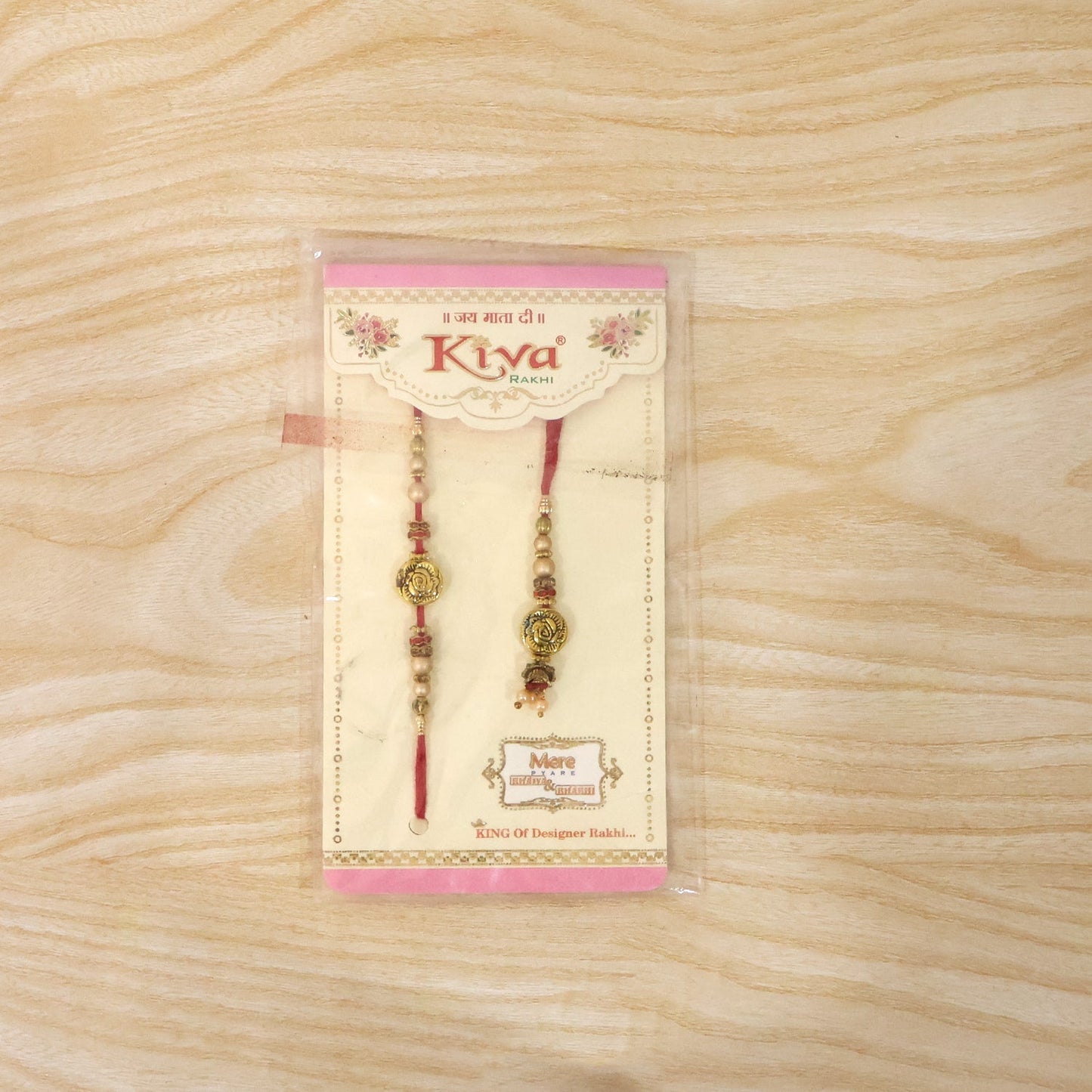 Antique Round Bhabhi Rakhi with pearl drop displayed on white background