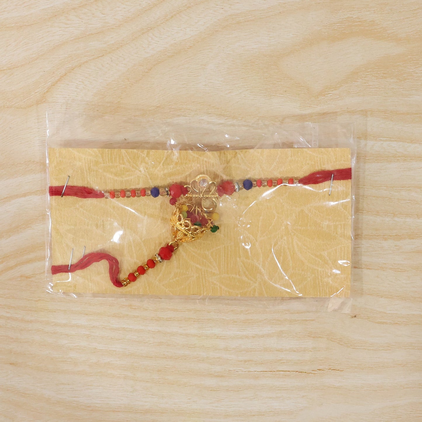 Om Charm Bhabhi Rakhi with Jhumka Latkan angled view