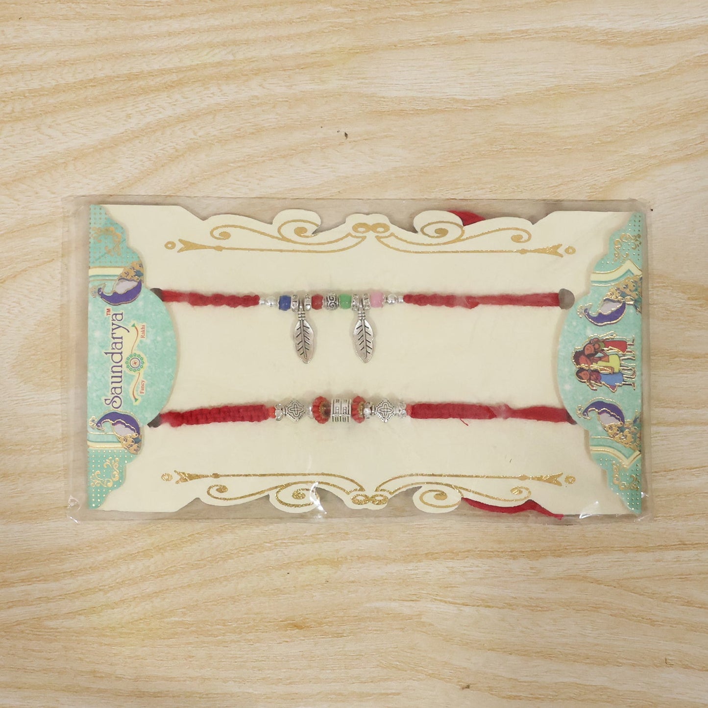 Decorative Leaf Charm Bhabhi Rakhi displayed on white background